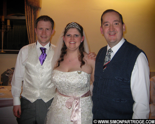 Bride and groom Sam and Ben with vintage wedding singer Simon Partridge